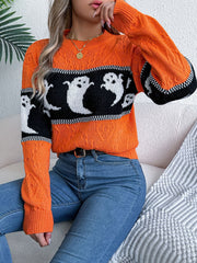Orange cable knit crewneck sweater with black and white ghost motif and ribbed cuffs.