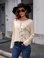 Ivory slouchy tee with butterfly graphic and long sleeves.
