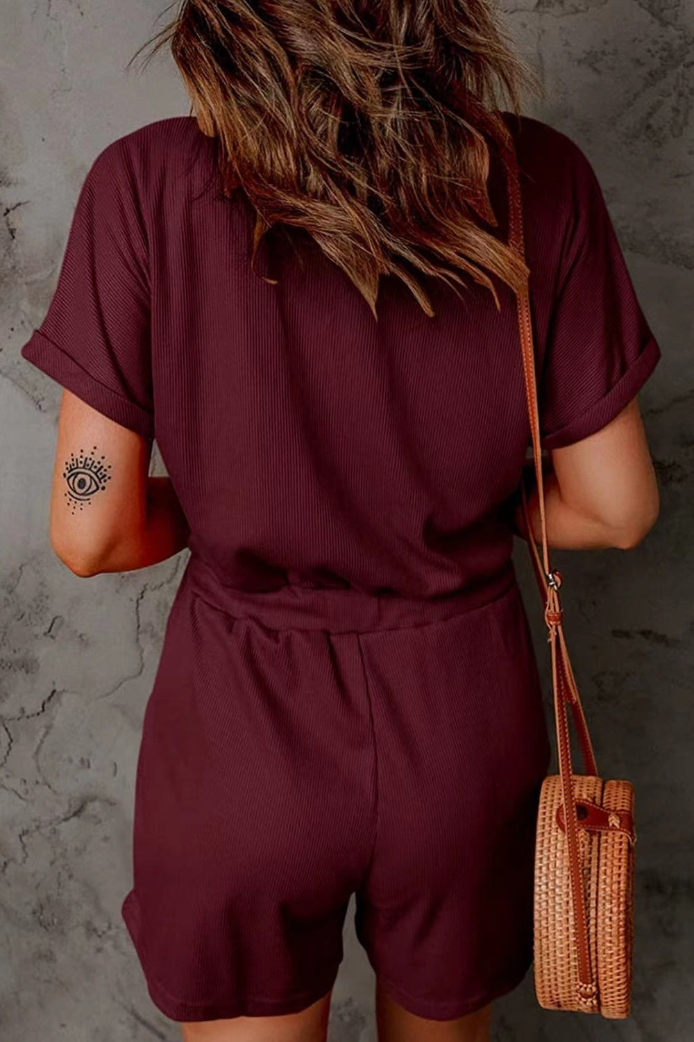 Burgundy ribbed V-neck romper with cuffed short sleeves and drawstring waist.