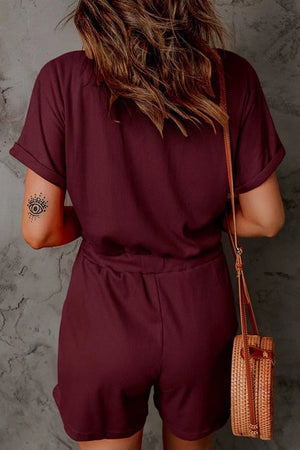Burgundy ribbed V-neck romper with cuffed short sleeves and drawstring waist.