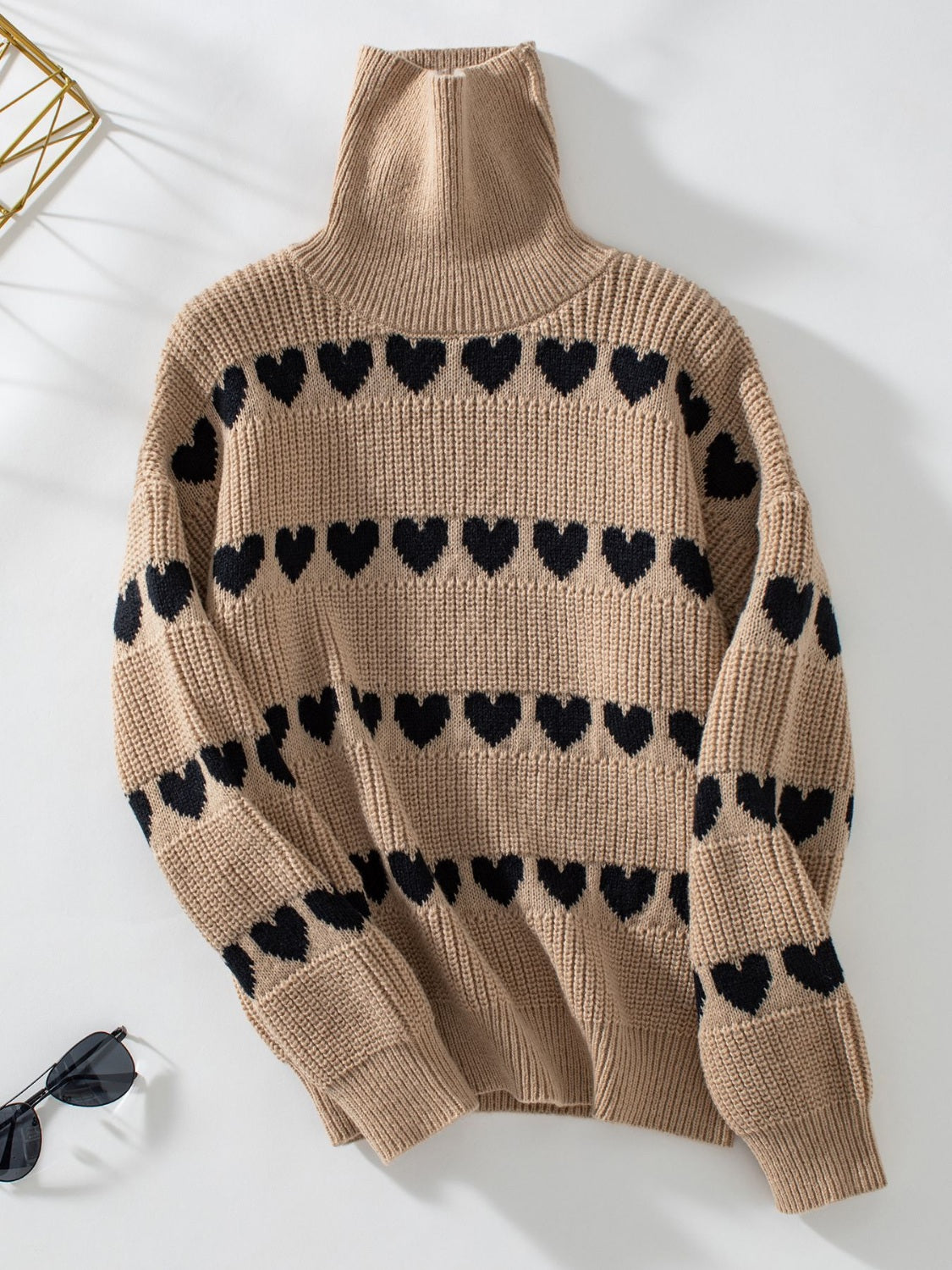 Taupe acrylic turtleneck sweater with black heart intarsia pattern.