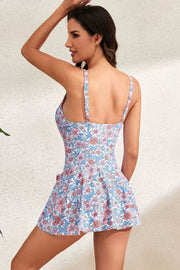 Floral tie-waist swim dress with skirt overlay and adjustable straps.