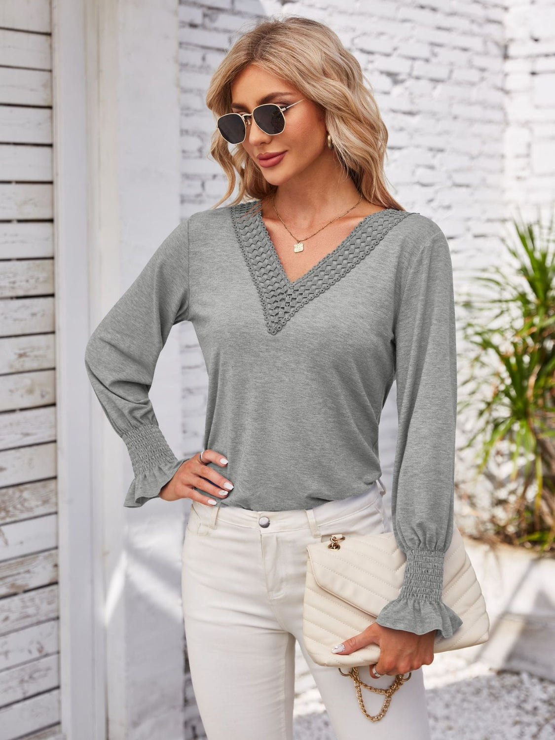 Gray v-neck blouse with lace trim and blouson sleeves