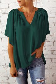 Green relaxed V-neck blouse with cap sleeves and gathered neckline detail.