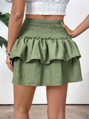 Tiered ruffle mini skirt in matcha green with a smocked waist and textured fabric.