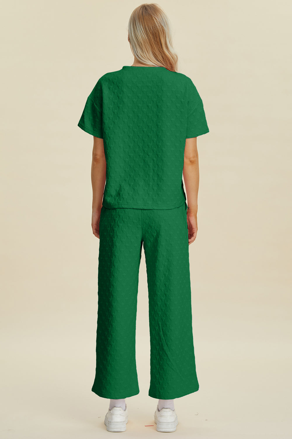 Dark green textured knit lounge set with wide leg pants and short sleeve top.
