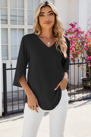 Black v-neck blouse with asymmetric split sleeves and a flowy fit.