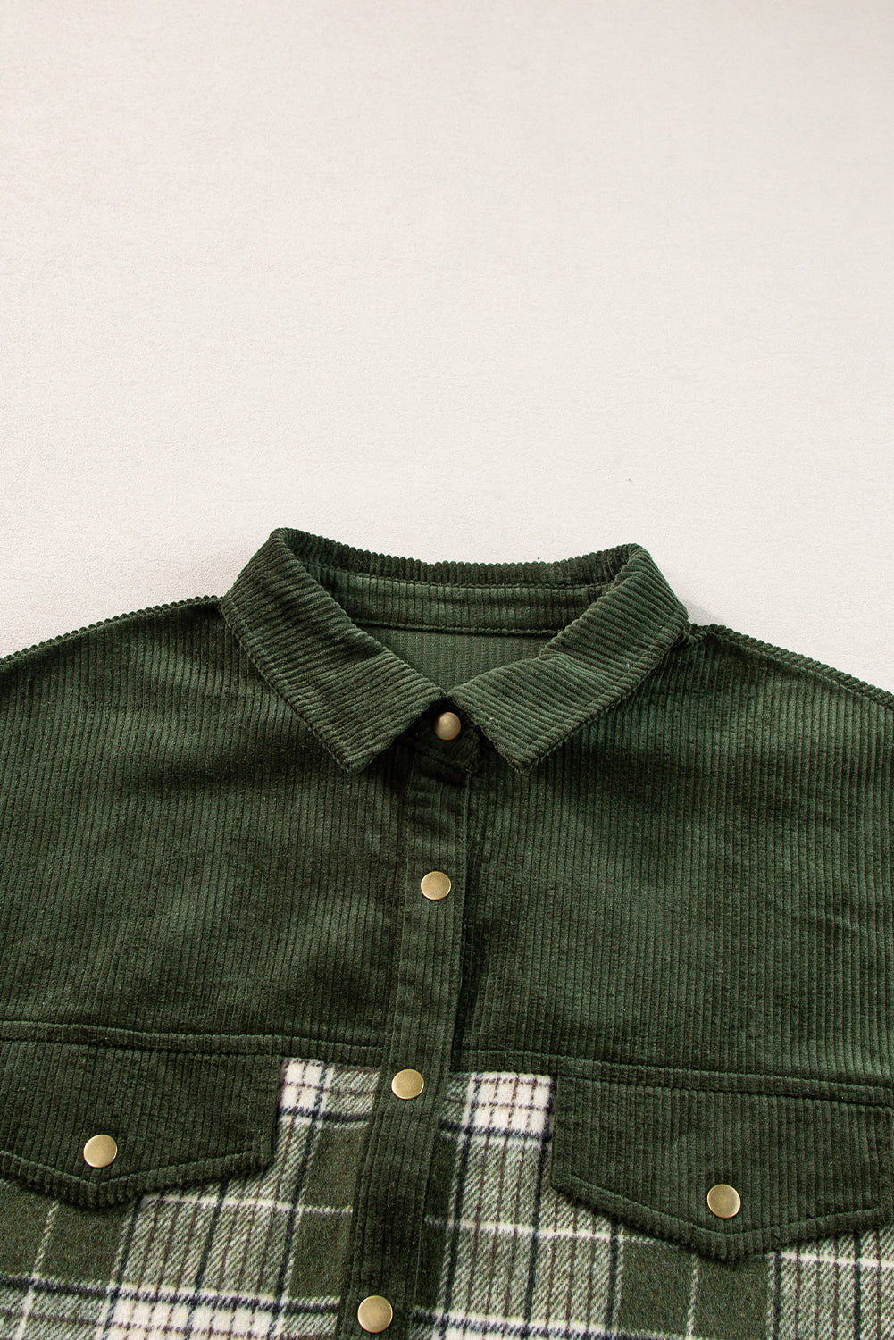 Corduroy yoke overshirt in Black Forest green with plaid lower panel and button details.