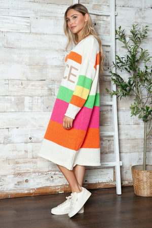 Beige midi sweater dress with rainbow stripes and "PEACE" lettering.