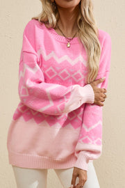Pink acrylic knit sweater with geometric pattern and colorblock detail.
