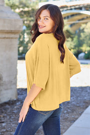 Yellow boxy dolman crop t-shirt with short sleeves and a relaxed fit.
