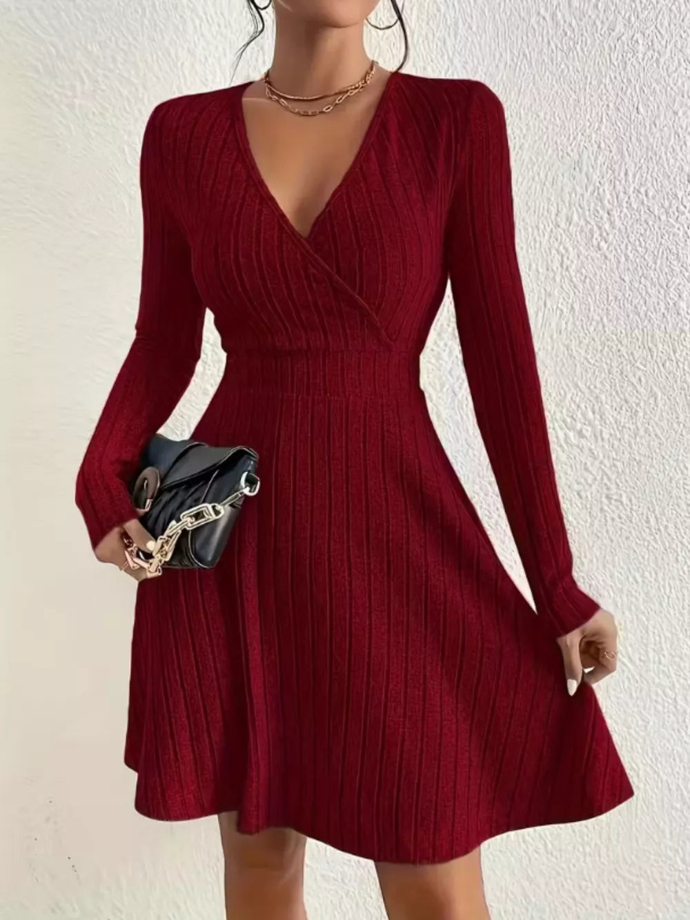 Burgundy ribbed wrap mini dress with V-neck and long sleeves.