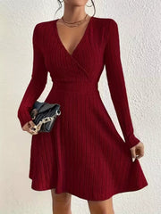 Burgundy ribbed wrap mini dress with V-neck and long sleeves.