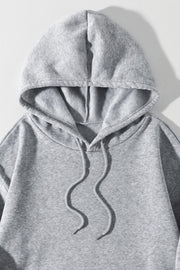 Gray oversized hoodie with drawstring and pouch pocket detail
