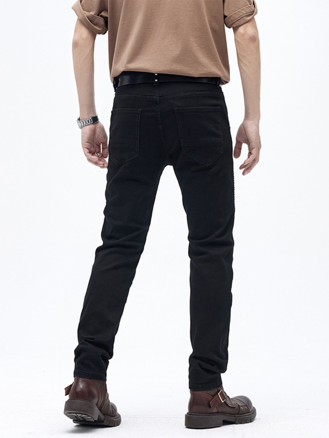 Black cotton slim fit moto jeans with ribbed panels and buttoned closure.