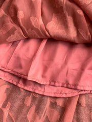 Rust embroidered tie-waist dress detail showing floral burnout fabric and lining.