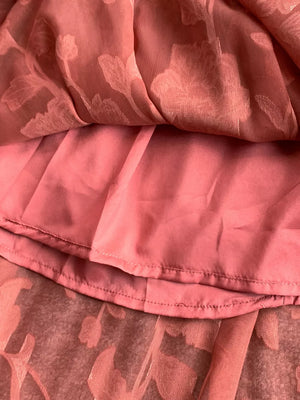Rust embroidered tie-waist dress detail showing floral burnout fabric and lining.