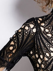 Elegant Black lace midi dress with delicate sleeves and intricate cutouts.