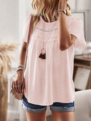 Blush pink textured puff sleeve blouse with lace yoke detail and short sleeves.