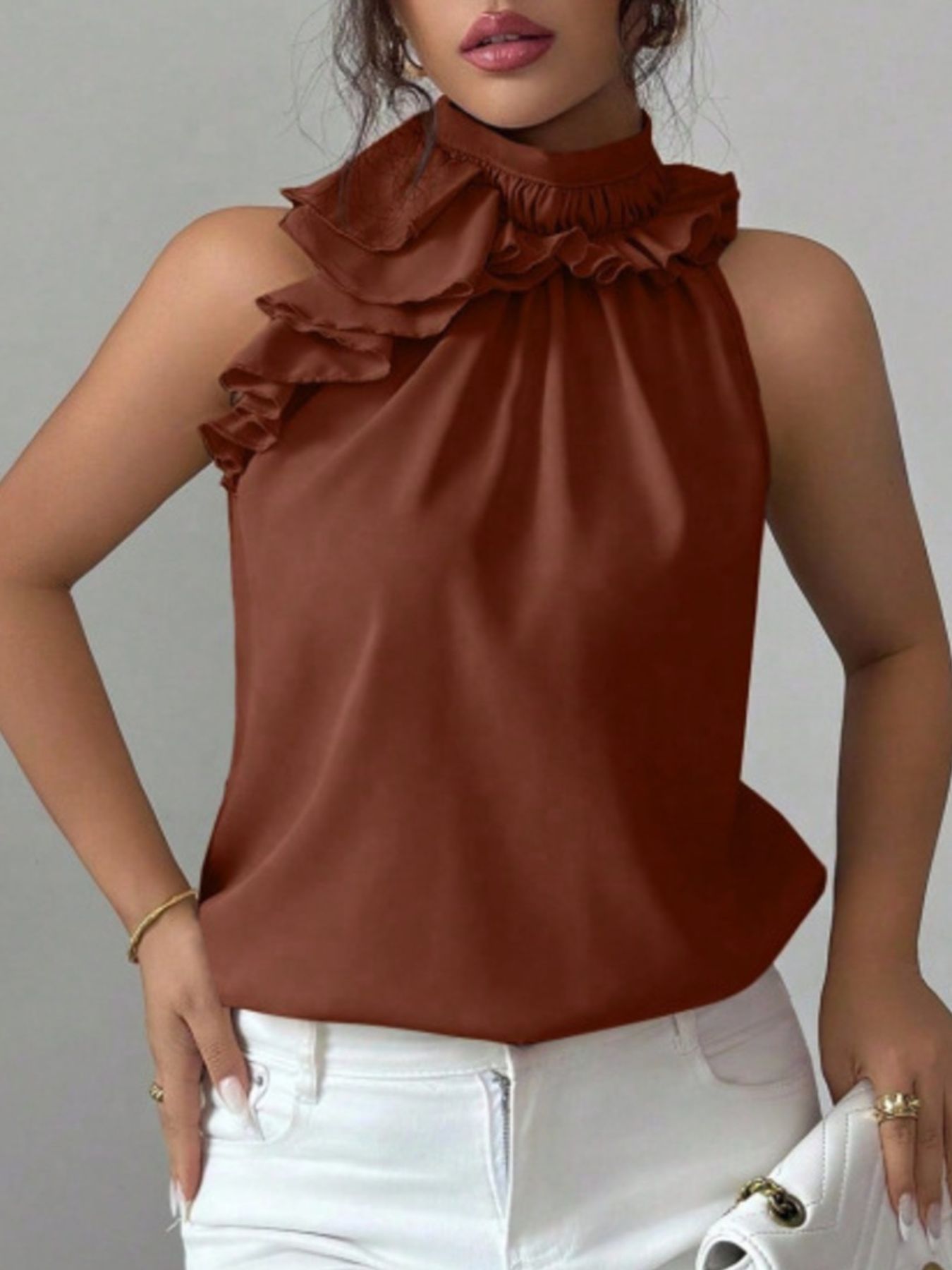 Ruffled high neck sleeveless top in red, black, apricot, or brown.