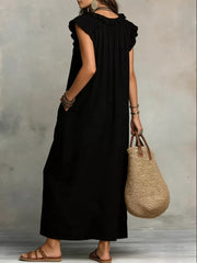 Black ruffled V-neck maxi dress with pockets and short sleeves.