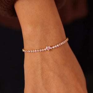 Gold tennis bracelet with pink heart zirconia charm and clear stones
