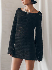 Black crochet mini dress with bell sleeves and a boat neck.