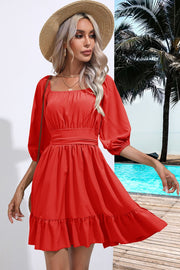 Red mini dress with square neck, puff sleeves, cinched waist, and ruffled hem.