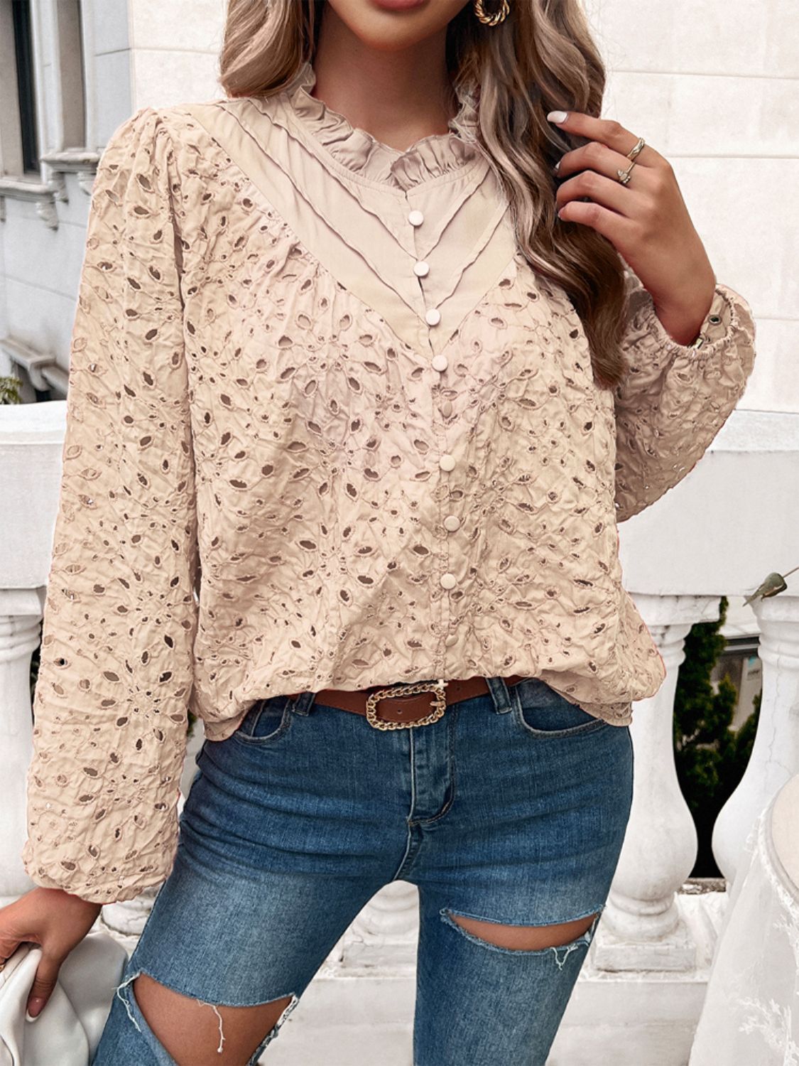 Tan eyelet embroidered blouse with ruffle collar and button front.