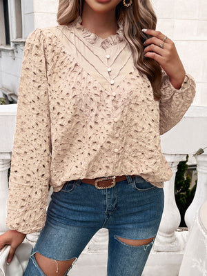 Tan eyelet embroidered blouse with ruffle collar and button front.