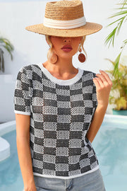 Checkerboard knit crewneck top in black and white with short sleeves.