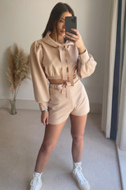 Blush pink cropped hoodie with puff sleeves and tie detail, paired with matching shorts.