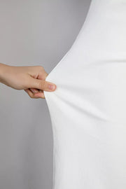 Casual white denim jeans showing fabric stretch