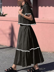 Black crochet co-ord set with scalloped trim, featuring a cropped top and maxi skirt.