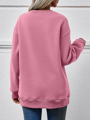 Blush pink crewneck sweatshirt with ribbed cuffs and hem, crew neckline, and long sleeves.