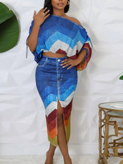 Asymmetrical chevron print crop top and high-slit denim skirt set.