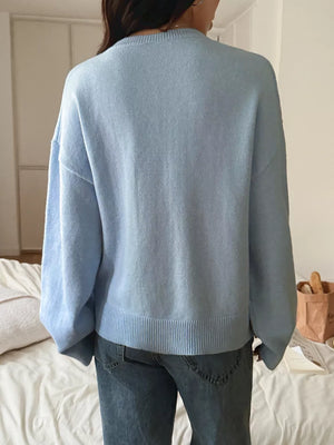 Light blue V-neck knit sweater with ribbed hem and cuffs, acrylic fabric.