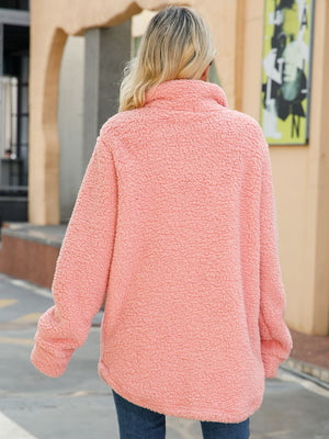 Teddy-texture shacket in blush pink with a high collar and button detail.