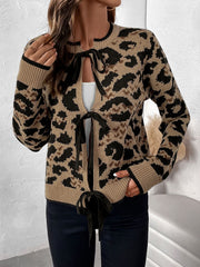 Tan leopard print acrylic knit cardigan with black bow-tie closure