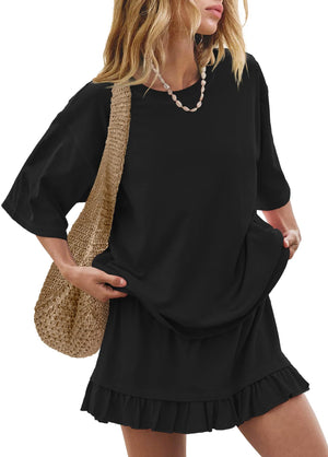 Black relaxed fit tee and ruffled skirt set with a straw bag and shell necklace.