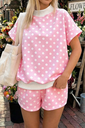 Pink polka dot polyester top and shorts set with white trim and collar.