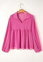 Hot pink textured blouse with gathered yoke, collar, and balloon sleeves.