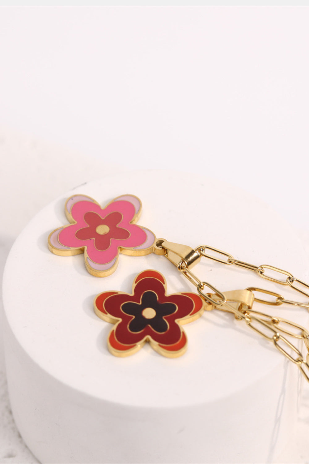 Enamel floral pendant necklace in Deep Red and Pink on a gold-plated chain.