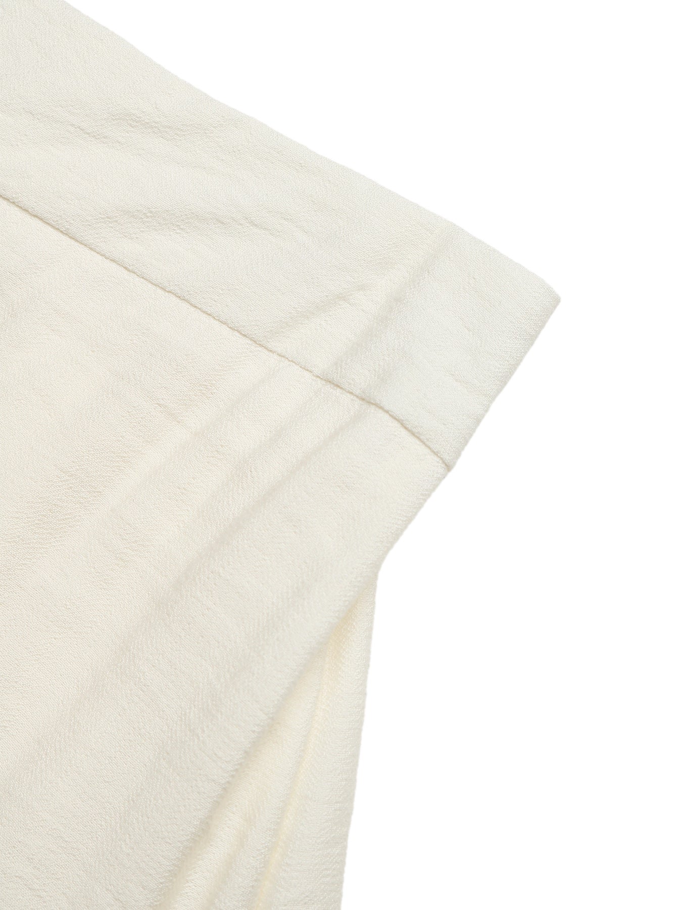Beige tiered midi skirt with wavy trim detail and textured fabric.