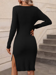 Black ribbed midi dress with long sleeves and a high slit.