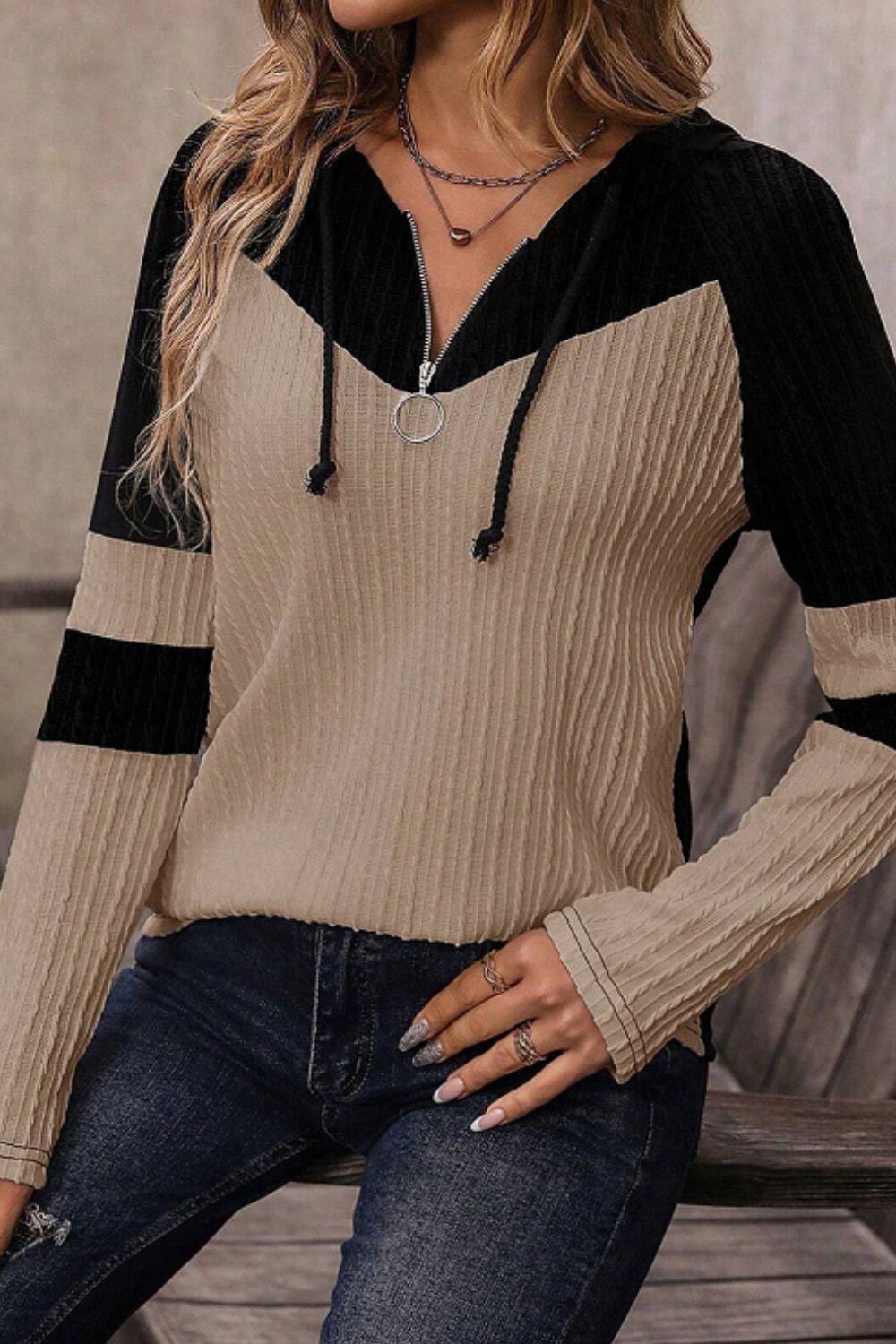 Colorblock ribbed zip-neck hoodie in mocha and black with ring zipper detail and drawstring hood.