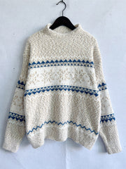 Geometric knit mockneck pullover in eggshell with blue and white fair isle pattern.