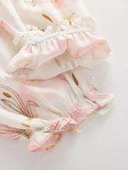 Baby bottoms with pink floral and bunny print, ruffled elastic cuffs, cotton fabric.