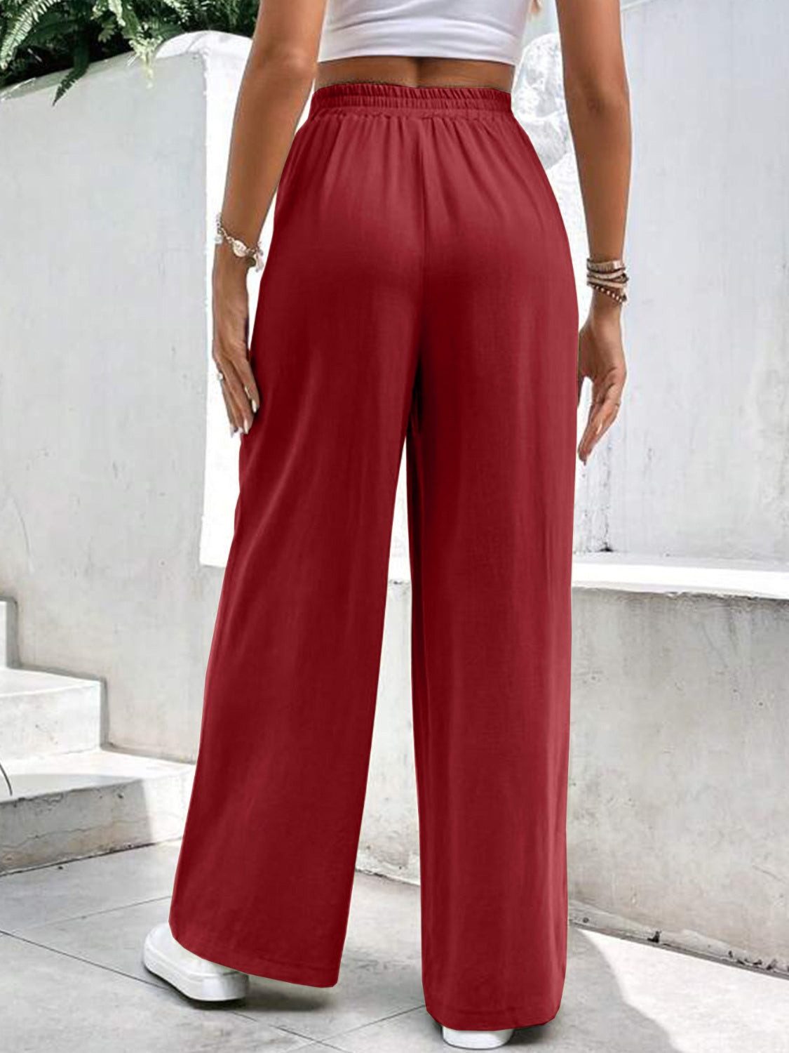 Burgundy relaxed drape palazzo trousers with pockets and a wide leg.
