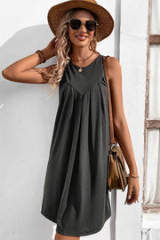 Dark gray sleeveless trapeze dress with pleated yoke detail